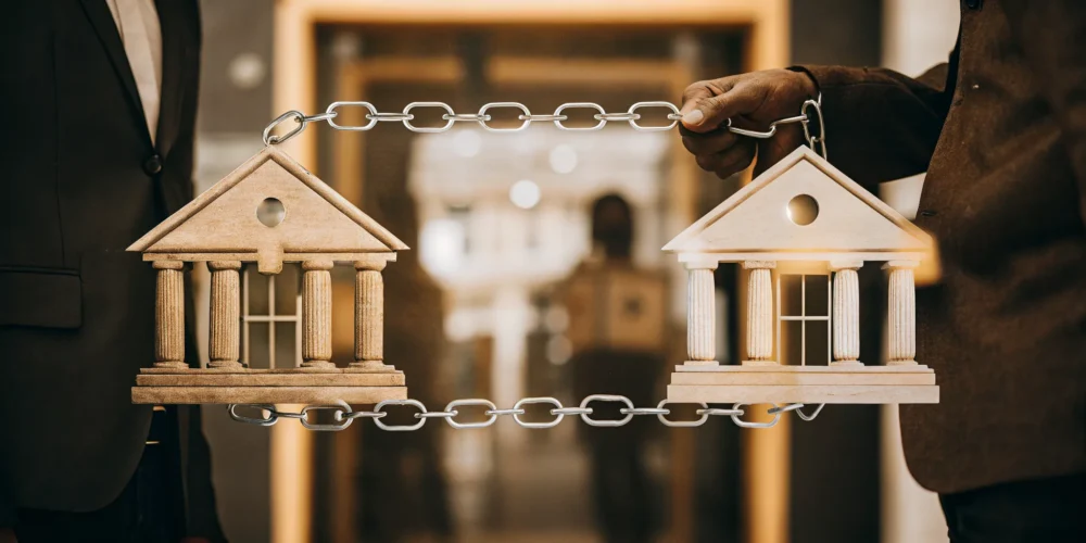 Comparison between a mortgage lender represented by a bank building and a loan officer representing borrower guidance