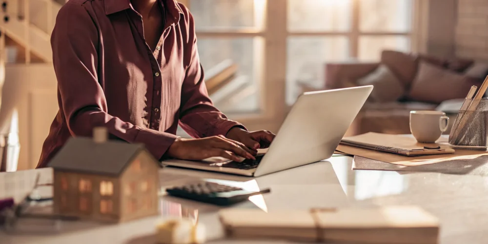 Self-employed professional working on mortgage documents at a home office desk