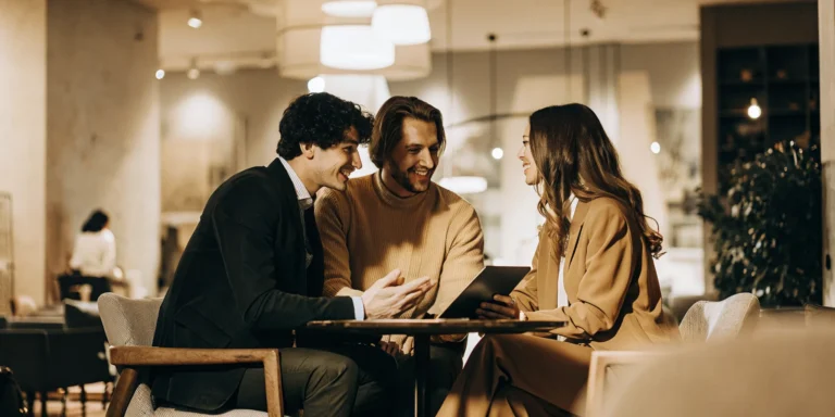 First-time homebuyer couple meeting with a mortgage loan officer to compare FHA loan rates
