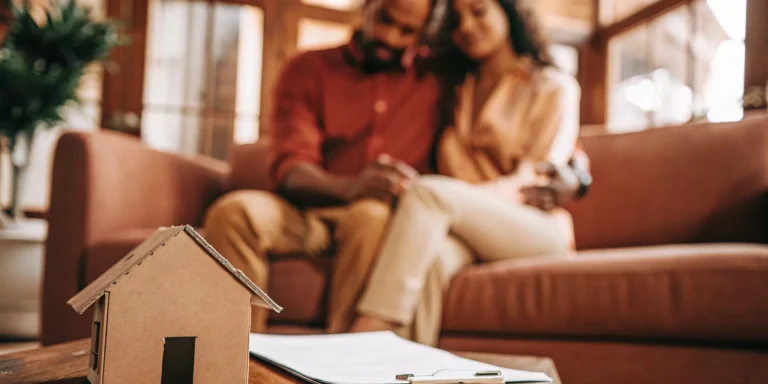 Homebuyer couple comparing mortgage options with a Loan Estimate in a bright fintech setting